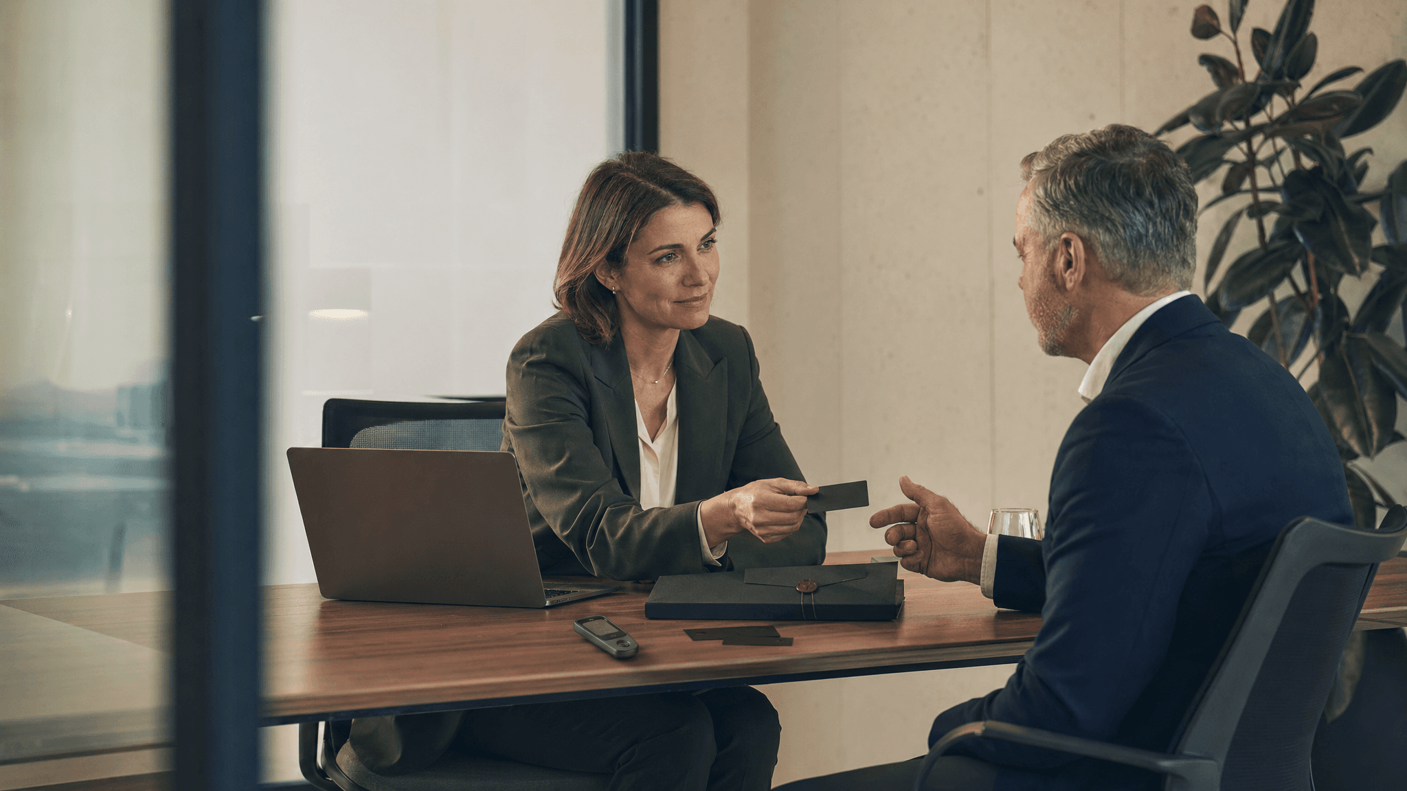 A financial advisor and customer reviewing a secure verification step